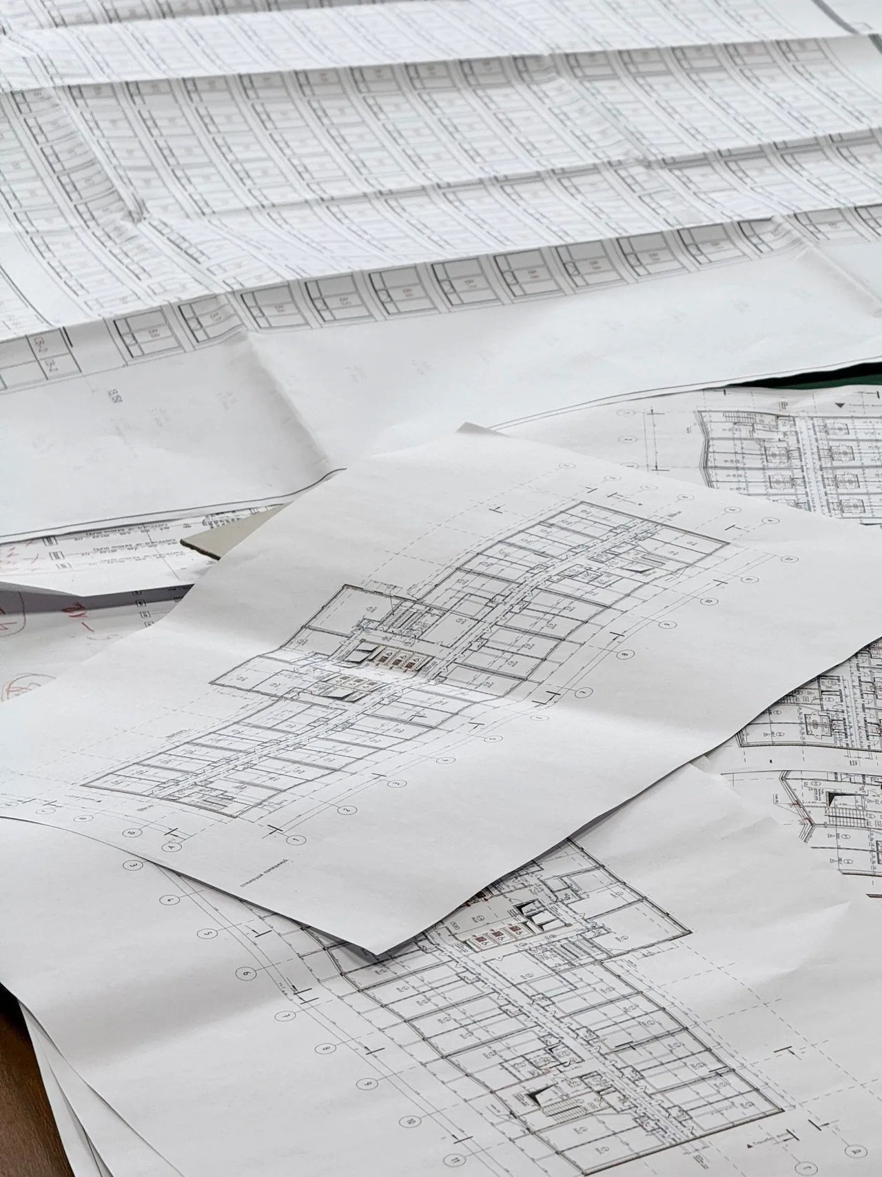 Architectural plans spread across a work table